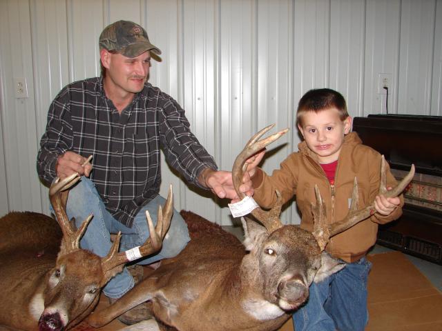 Jason (owner) & Son (Lane) holding two of the hunters bucks